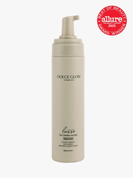 Dolce Glow Lusso Self-Tanning Mousse in branded taupe bottle with foam pump on light gray background with red Allure Best of Beauty seal in the top right corner